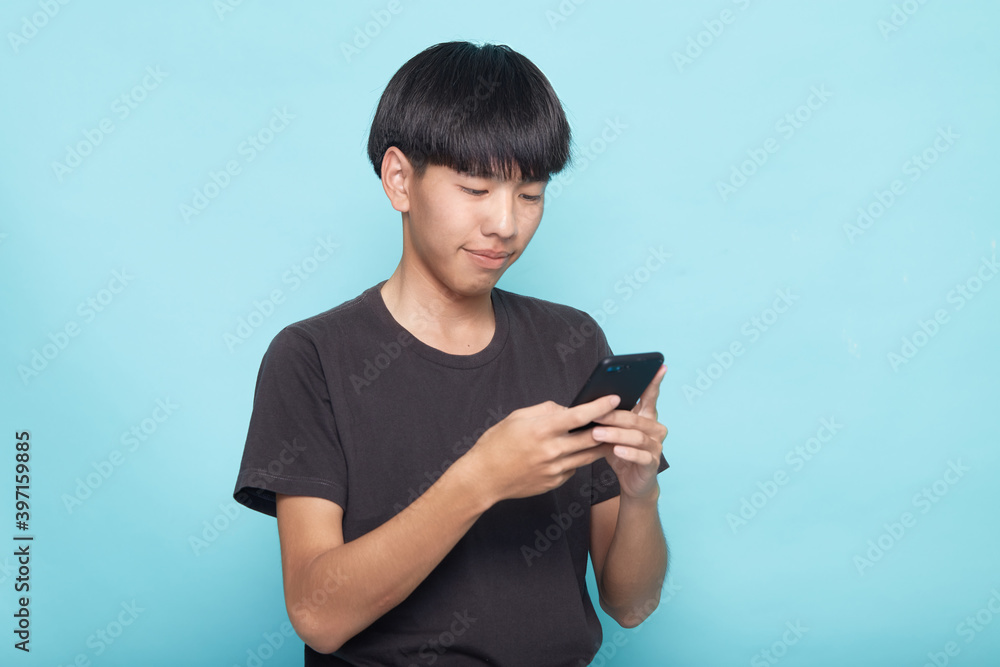 Fototapeta premium young man use smartphone on blue