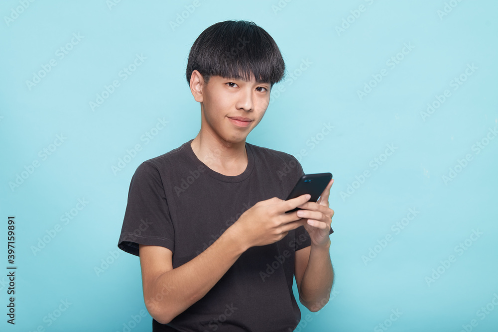 young man use smartphone on blue young man use smartphone on blue