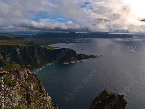 Stunning panorama view of the northern coastline of Andøya island, Vesterålen, Norway with rugged mountains, cliffs and beaches on summer day with clouds viewed from Måtinden peak.