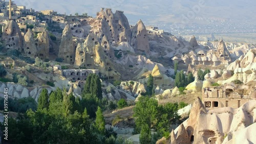 Guvercinlik Valley and town at Cappadocia, Turkey. Attraction point and popular touristic place for tourist and tour company. Fairy chimneys, sandstones at national park. Old rocks and limestones. photo