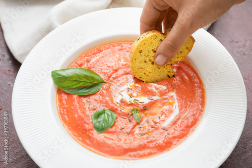 Hand dipping toasted bread ...