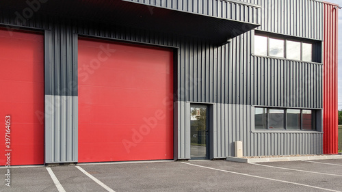 modern industrial unit with two red roller doors photo