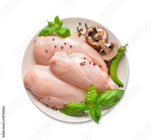 Plate with raw chicken fillet, mushrooms and basil on white background