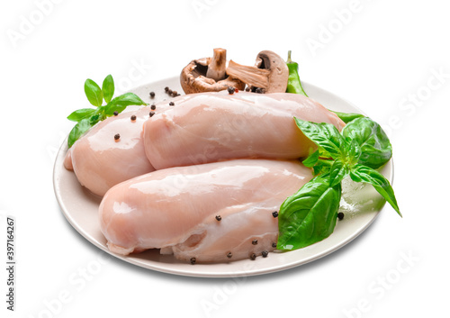Plate with raw chicken fillet, mushrooms and basil on white background