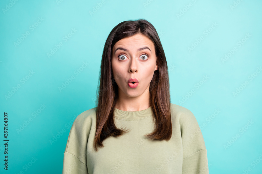 Photo portrait of impressed woman isolated on vivid teal colored background Photo portrait of impressed woman isolated on vivid teal colored background
