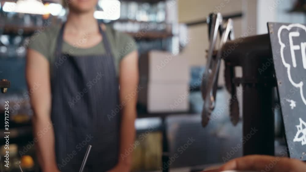 Female barista hold coffee cup serving a client at the coffee shop