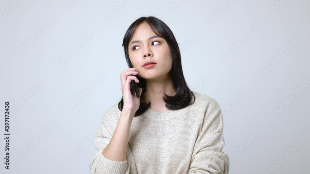 Young asian woman talking on smartphone and feeling happy.4K Resolution. Young asian woman talking on smartphone and feeling happy.4K Resolution.