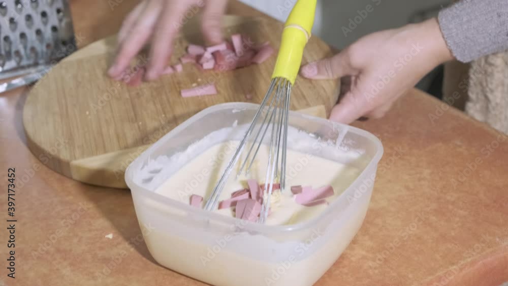 Woman chef mixes with the turned off mixer the egg yolk with sugar in a glass bowl. Woman chef mixes with the turned off mixer the egg yolk with sugar in a glass bowl.