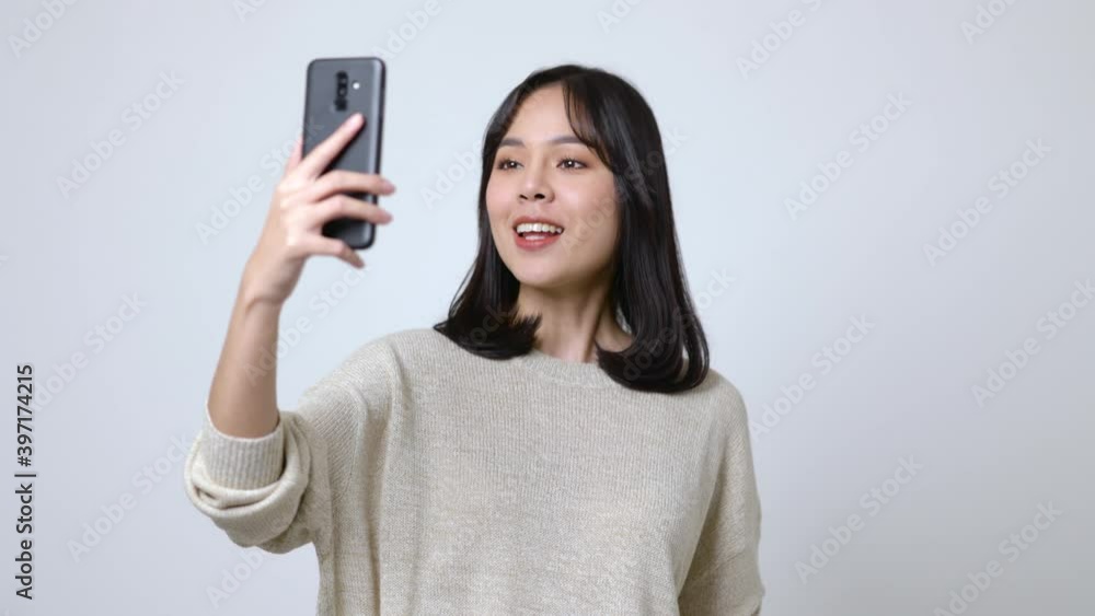 Young asian beautiful woman video conference with friend on smartphone. Video call online social media. Young asian beautiful woman video conference with friend on smartphone. Video call online social media.