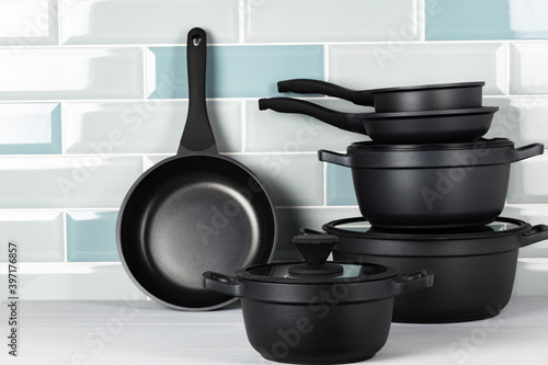 Set of black cookware on kitchen counter