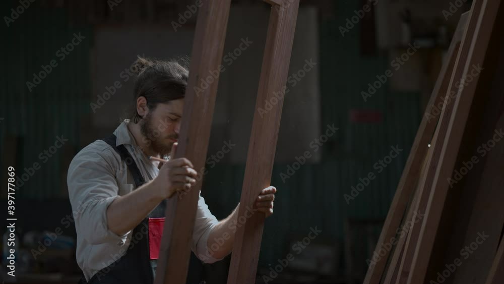 Carpenter man doing woodwork in workshop Carpenter man doing woodwork in workshop