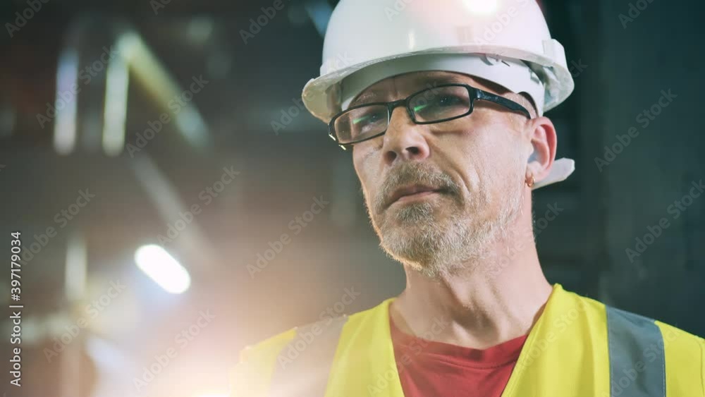 Engineer keeping a check on production process. Face closeup. Engineer keeping a check on production process. Face closeup.