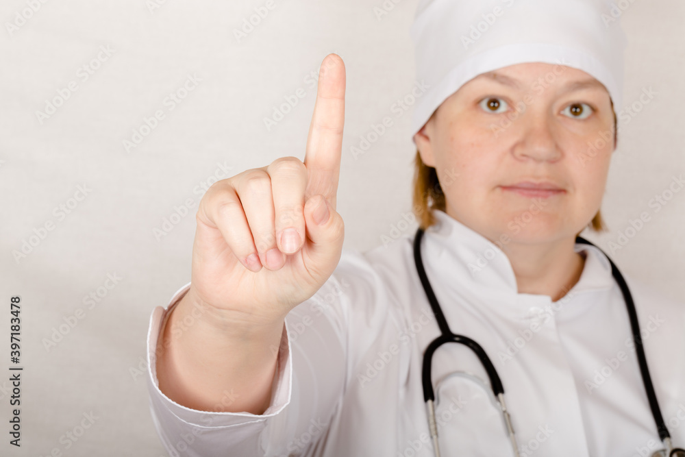 Female doctor with phonendoscope on her neck shows you some sign for preventation