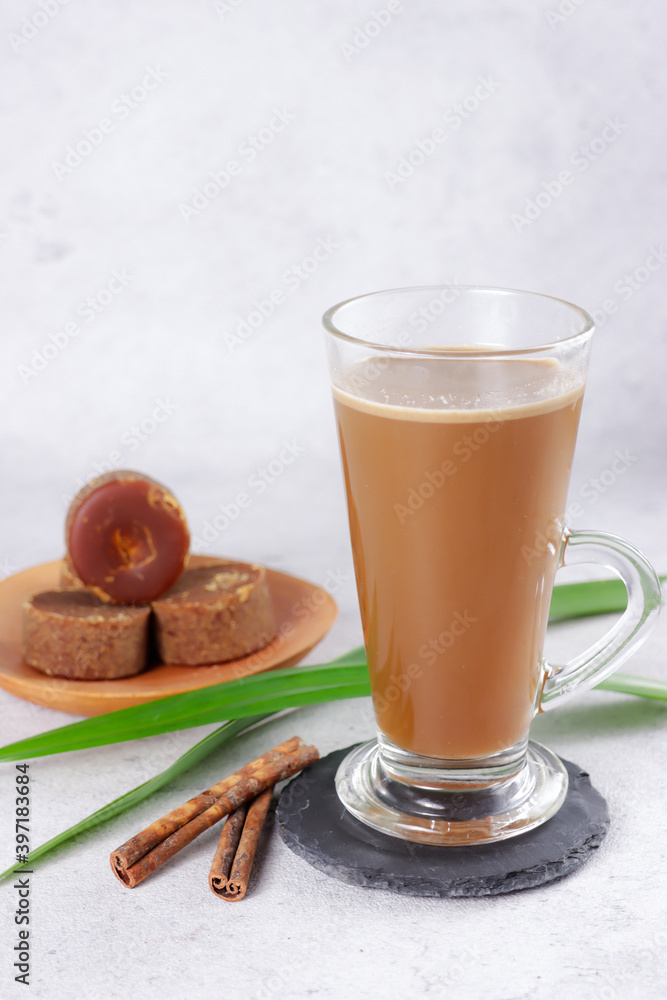 Bajigur. Javanese traditional hot drink of herbal coffee latte made from coconut milk, coffee, ginger, palm sugar and cinnamon. Bajigur. Javanese traditional hot drink of herbal coffee latte made from coconut milk, coffee, ginger, palm sugar and cinnamon.