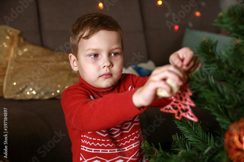 Wallpaper Mural Little happy boy is decorating a Christmas tree. Torontodigital.ca