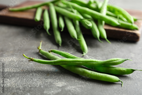 Fresh green beans on grey table, closeup