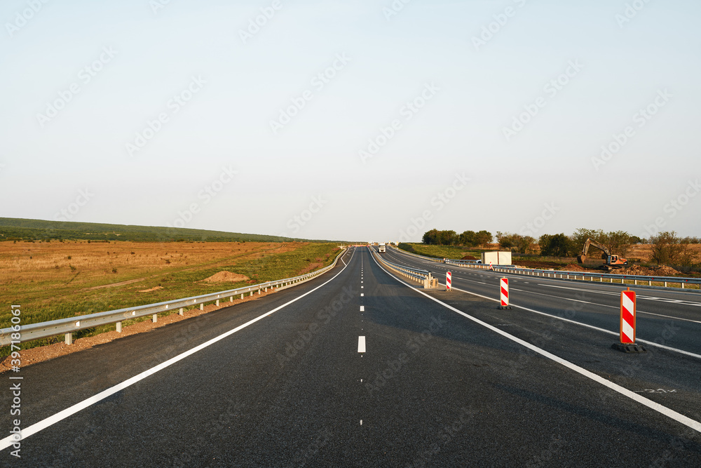 Empty highway with asphalt road and cloudy sky