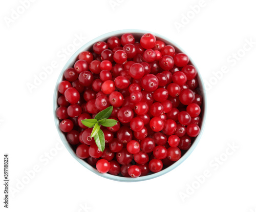 Fresh ripe cranberries with leaves in bowl isolated on white, top view