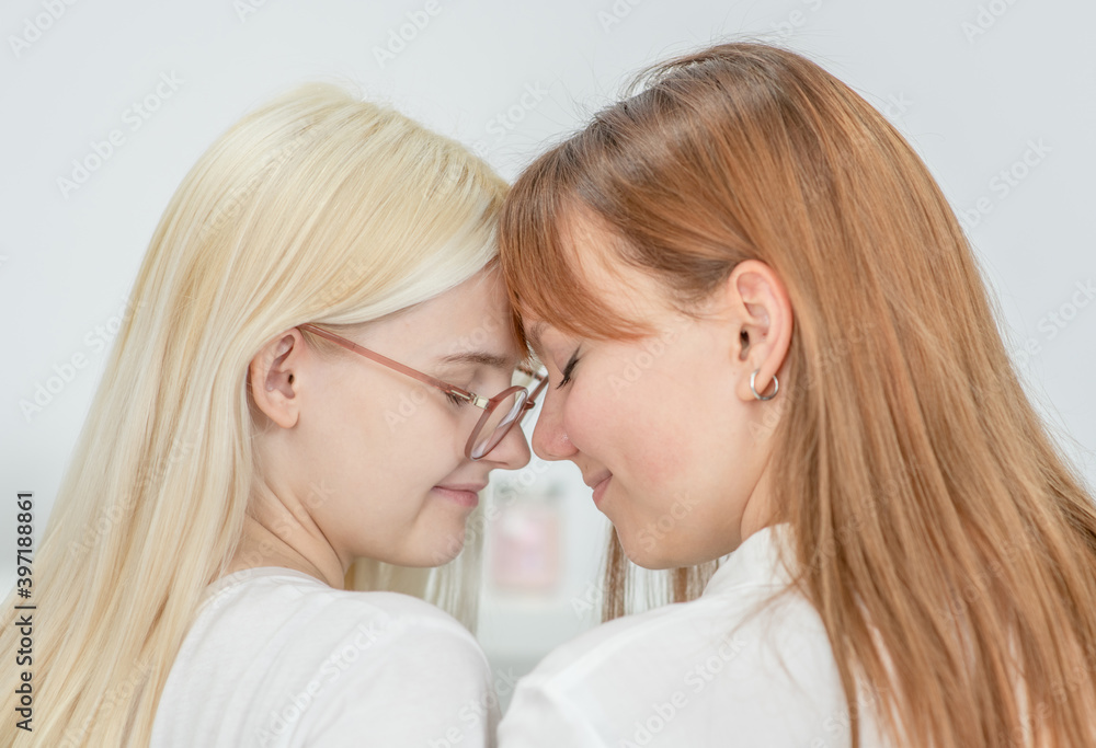 Two girls press their foreheads to each other. Homosexual relationship. LGBT concept Two girls press their foreheads to each other. Homosexual relationship. LGBT concept