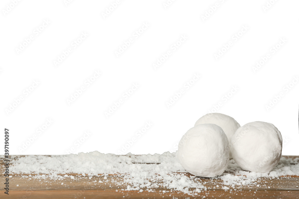 Snowballs on wooden table against white background. Space for text Snowballs on wooden table against white background. Space for text