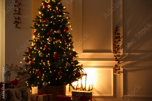 Beautiful living room interior with decorated Christmas tree and gifts © New Africa