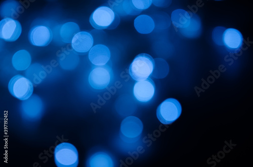 Abstract pattern of blue bokeh lights on black background
