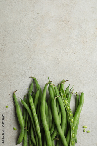 Fresh green beans on light grey table, flat lay. Space for text