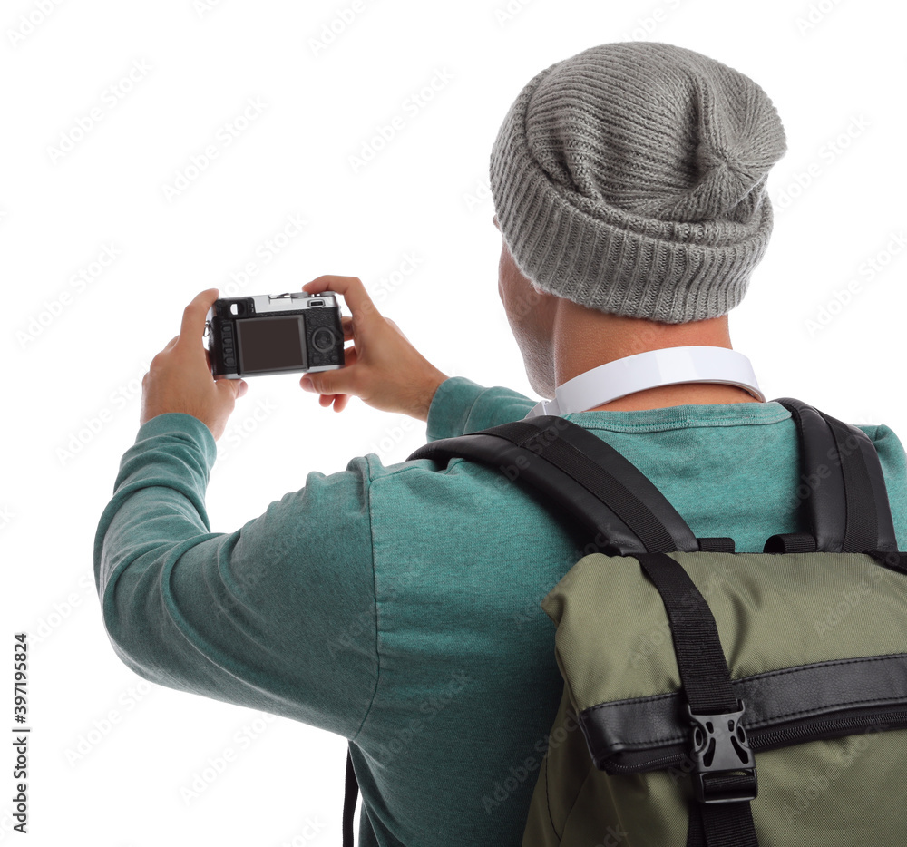 Man with backpack taking picture on white background, back view. Autumn travel Man with backpack taking picture on white background, back view. Autumn travel