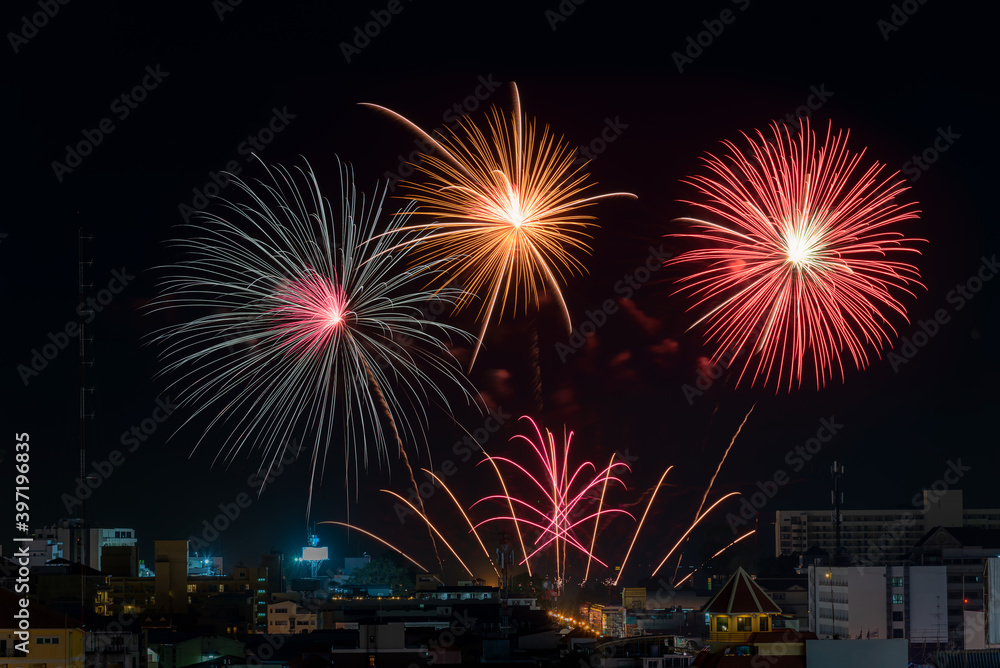 Beautiful sparkling fireworks of various colors display on dark sky.