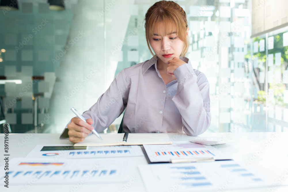 Young Charming asian businesswoman sitting working on laptop in office.