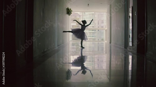 Silhouette of little blerina girl in an elegant dress dancing