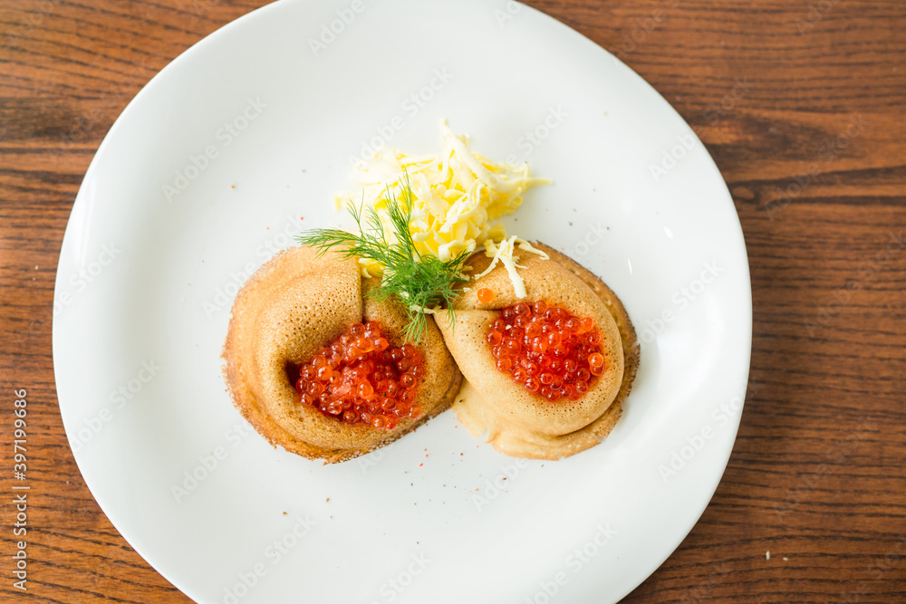 fresh pancakes with red caviar and oil fresh pancakes with red caviar and oil