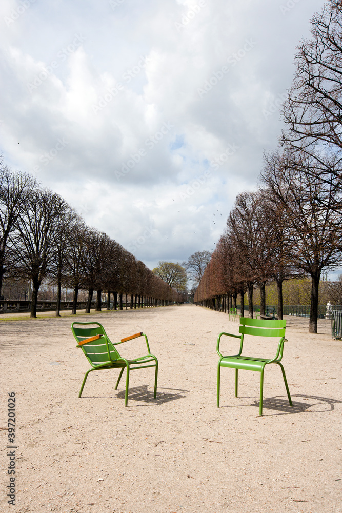 Two  Green Chairs on a path In Paris, France