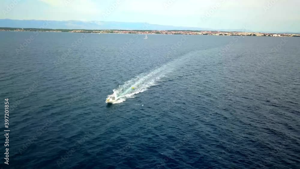 Flight over a mooving boat on the Adriatic Sea near Zadar with the Velebit Mountains in the background Croatia 4K Flight over a mooving boat on the Adriatic Sea near Zadar with the Velebit Mountains in the background Croatia 4K