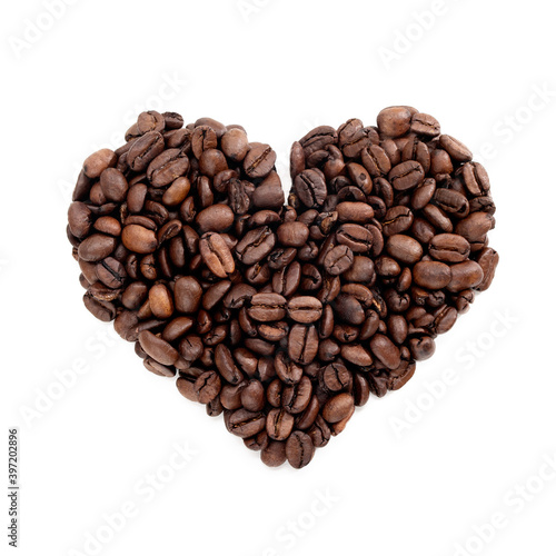 Heart shaped roasted coffee beans on completely white background