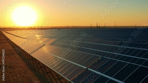 Drone footage of a solar power plant at sunset photo