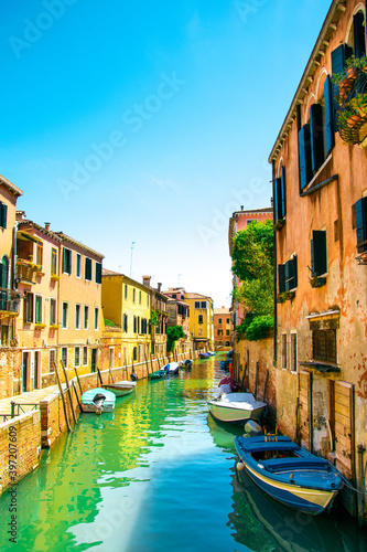 Sunny and beautiful Venice. Old colorful buildings, narrow streets and bridges. Monuments of Venice in Italy 