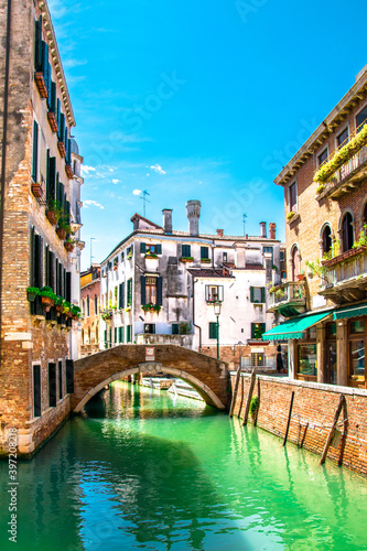Fototapeta Naklejka Na Ścianę i Meble -  Sunny Venice, Italy. Old colorful buildings, narrow streets and bridges. Monuments of Venice