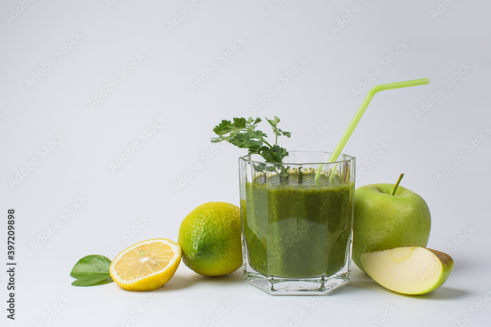 Fototapeta premium Detox cocktail from raw green fruits and vegetables and lettuce and parsley