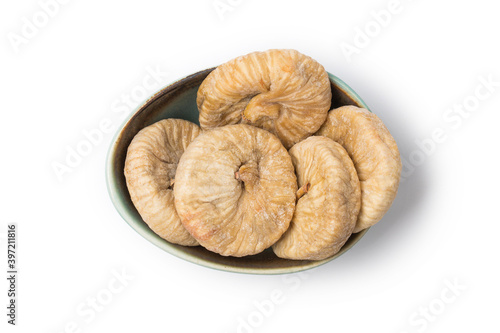 Dried fig on plate on white background