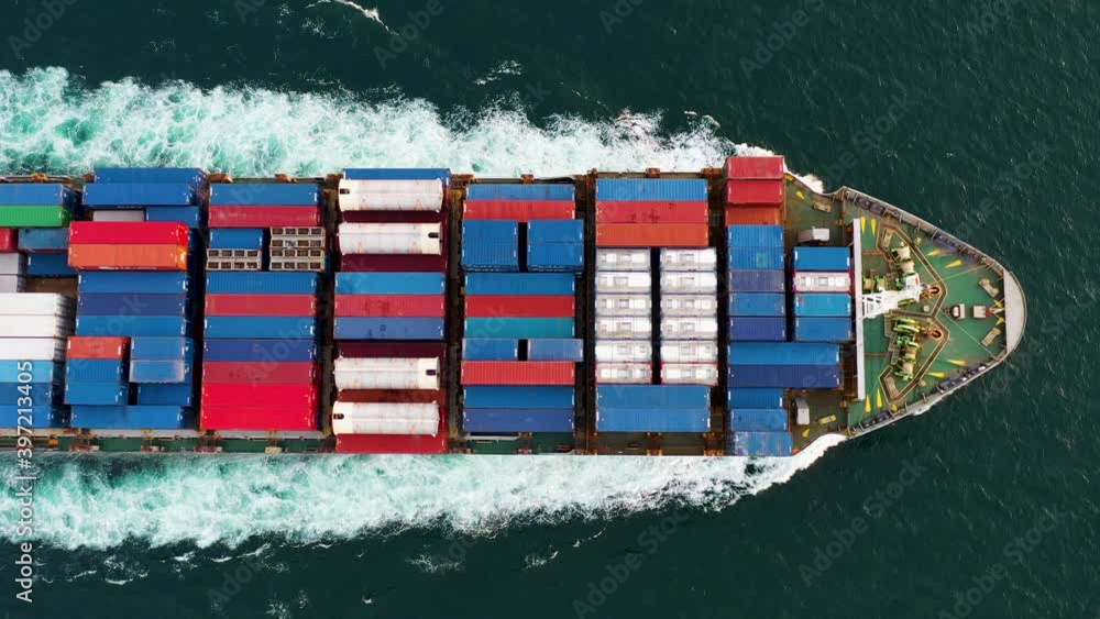 Aerial top view of cargo ship carrying container and running for export goods from cargo yard port to custom ocean concept freight shipping 4k video 