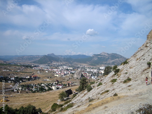 The City Of Sudak. The surroundings of the monument of architecture of the Genoese fortress. City buildings are closely adjacent to the historical fortress walls and towers.