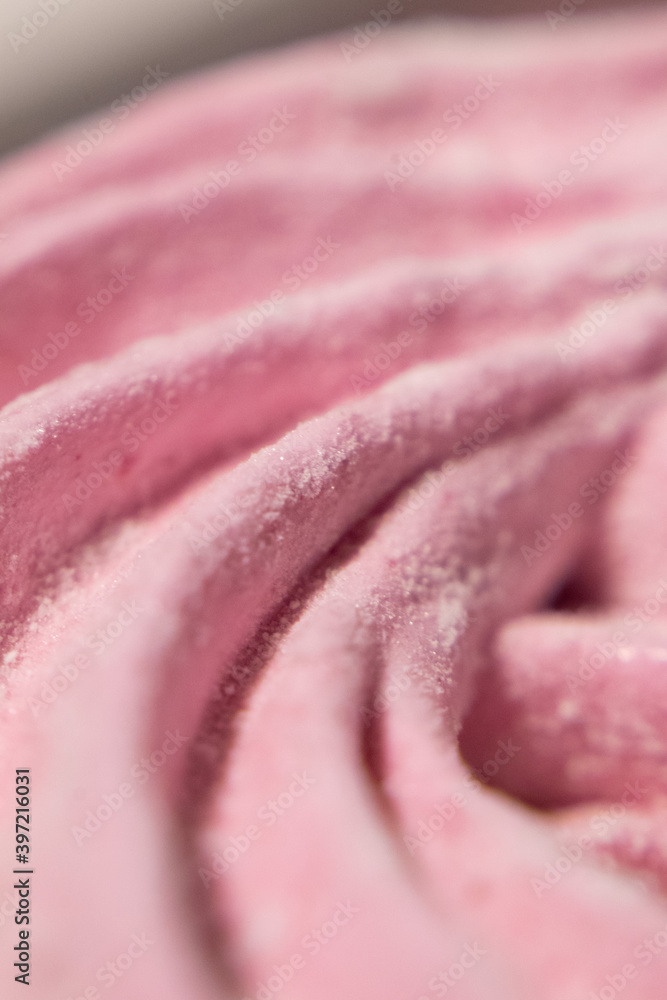 Obraz premium Abstract macro lines meringue. Colored sweet pink dessert zephyr or marshmallows in pastel colors. close-up, selective focus.