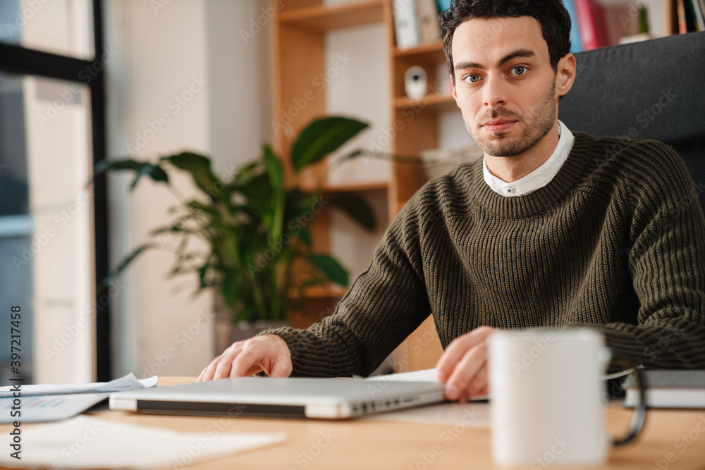 Entrepreneur working with a laptop and documents Entrepreneur working with a laptop and documents