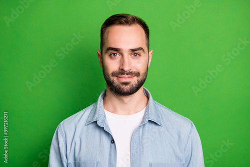 Portrait of optimistic man wear blue shirt isolated on green color background