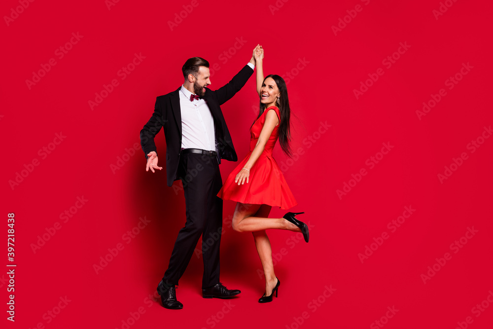 Full body portrait of carefree handsome guy attractive lady have fun enjoy dance isolated on red color background