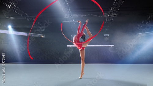 Rhythmic gymnast in professional arena. photo