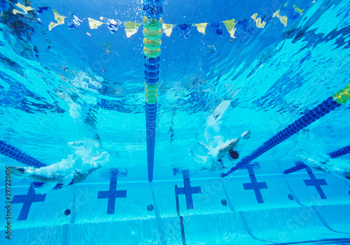 Underwater view of professional participants racing in pool