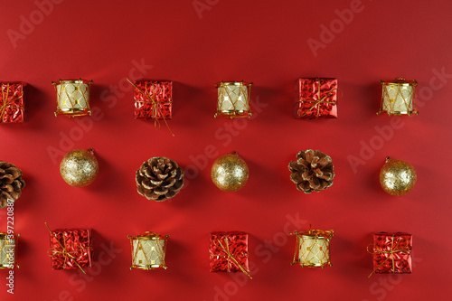 Christmas decorations on the Christmas tree pattern on a red background. Top view  as a background. New Year holiday