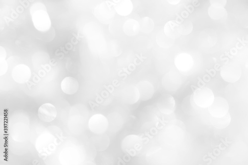 White sparkles with blurry circles texture, soft bokeh for a beautiful new year screensaver. Template for decoration of a holiday postcard, web design.